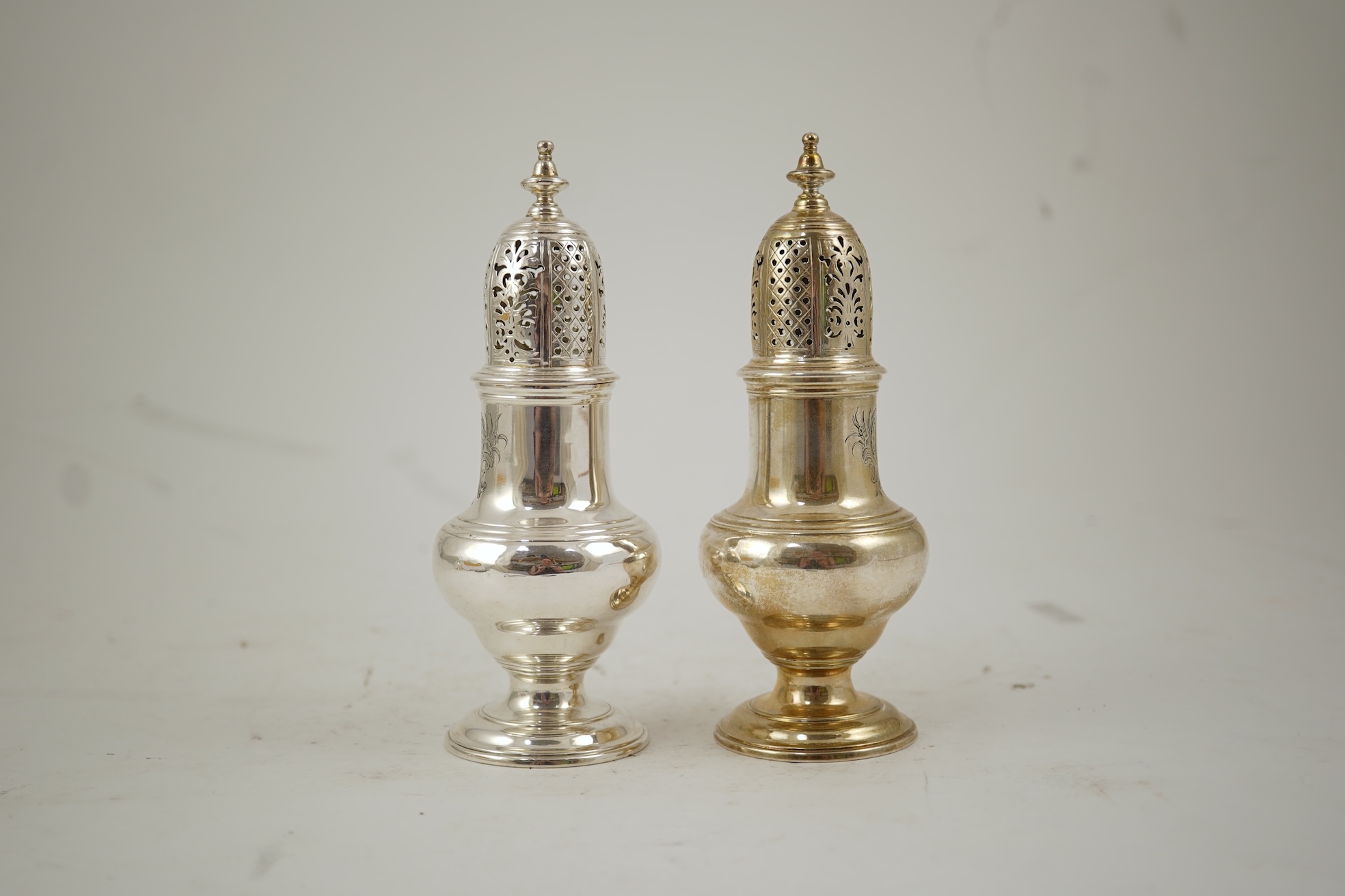 A pair of George II silver baluster sugar casters, by Samuel Wood